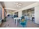 Community patio with tables, chairs, and fans, set behind sliding glass doors at 8447 Orleans N, Pinellas Park, FL 33781