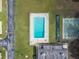 Aerial view of the pool and shuffleboard courts in a sunny, well-kept community at 8447 Orleans N, Pinellas Park, FL 33781