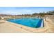 Community pool with a chain-link fence and lounge chairs, set against a backdrop of residential buildings at 8447 Orleans N, Pinellas Park, FL 33781