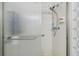 Shower features glass doors, tile surround, and updated shower head at 8447 Orleans N, Pinellas Park, FL 33781