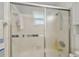 Bathroom shower featuring frosted sliding glass doors and tile surround at 8447 Orleans N, Pinellas Park, FL 33781