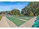 Outdoor shuffleboard courts with green surfaces and bench seating under a bright sky at 8447 Orleans N, Pinellas Park, FL 33781
