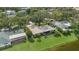 Charming single-story home with a well-manicured lawn and mature landscaping, including views of a pond at 8515 Macoma Ne Dr, St Petersburg, FL 33702