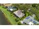 Beautiful aerial view of a home with a backyard overlooking the lake and lush landscaping at 8515 Macoma Ne Dr, St Petersburg, FL 33702