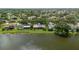 Scenic waterfront home with lush green lawn and mature trees offers serene living by the water at 8515 Macoma Ne Dr, St Petersburg, FL 33702
