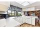 Bright kitchen with white counters and cabinets, a window with views, and an open layout at 8515 Macoma Ne Dr, St Petersburg, FL 33702
