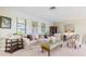 Bright living room featuring large windows, neutral paint, and plush seating arrangements at 8515 Macoma Ne Dr, St Petersburg, FL 33702