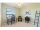 Bright home office featuring a desk, vintage decor, and a calming view of the outdoors at 8515 Macoma Ne Dr, St Petersburg, FL 33702