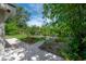 Scenic backyard view with a private dock and lush greenery, offering a peaceful waterfront retreat at 8701 Driftwood Drive Dr, Tampa, FL 33615