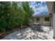 Backyard patio set among lush trees features bistro lights and offers relaxing ambiance at 8701 Driftwood Drive Dr, Tampa, FL 33615