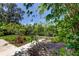 Beautifully landscaped backyard featuring a wooden bridge leading to a private canal at 8701 Driftwood Drive Dr, Tampa, FL 33615