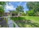 Spacious backyard featuring a patio area and lush landscaping, perfect for outdoor living and entertaining at 8701 Driftwood Drive Dr, Tampa, FL 33615