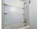 Clean, updated bathroom featuring a streamlined tub and shower combination with built-in shelving at 8701 Driftwood Drive Dr, Tampa, FL 33615