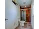 Bathroom featuring tiled shower with glass door and new toilet at 8701 Driftwood Drive Dr, Tampa, FL 33615