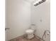 Simple bathroom features a standard toilet and tile flooring, awaiting modern updates at 8701 Driftwood Drive Dr, Tampa, FL 33615