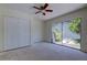 Cozy bedroom featuring a closet and sliding glass doors leading to outdoor views at 8701 Driftwood Drive Dr, Tampa, FL 33615