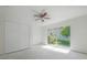 Bright bedroom featuring a ceiling fan, closet, and a sliding glass door at 8701 Driftwood Drive Dr, Tampa, FL 33615