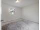 Empty bedroom with natural light streaming through a window; ready for personalization at 8701 Driftwood Drive Dr, Tampa, FL 33615