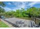 Close-up of the private dock with lush greenery in the background, ideal for boating enthusiasts at 8701 Driftwood Drive Dr, Tampa, FL 33615
