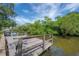 Exterior view of dock on the water, perfect for boating and enjoying waterfront living with lush green surroundings at 8701 Driftwood Drive Dr, Tampa, FL 33615