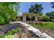 View of the house exterior with a walkway and lush landscaping leading to the front entrance at 8701 Driftwood Drive Dr, Tampa, FL 33615