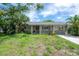 Charming single-story home with inviting front porch, lush landscaping, and freshly manicured lawn at 8701 Driftwood Drive Dr, Tampa, FL 33615