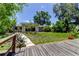 View of the house exterior with a wooden dock, walkway, and lush landscaping in the front yard at 8701 Driftwood Drive Dr, Tampa, FL 33615