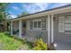 Charming front porch featuring classic columns, shuttered windows, and a welcoming entryway at 8701 Driftwood Drive Dr, Tampa, FL 33615