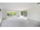 Bright living room with tile floors, large windows and sliding glass doors to the patio at 8701 Driftwood Drive Dr, Tampa, FL 33615