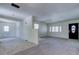 Bright living space connecting to the laundry and front entryway, enhanced with tile flooring at 8701 Driftwood Drive Dr, Tampa, FL 33615