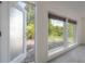 Bright living room featuring lots of natural light from multiple windows and an open door at 8701 Driftwood Drive Dr, Tampa, FL 33615