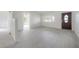 Spacious living room with neutral tile flooring, an oval-glass front door, and large windows for natural light at 8701 Driftwood Drive Dr, Tampa, FL 33615