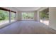 Spacious living room featuring sleek, light-colored floors and sliding door access to the backyard at 8701 Driftwood Drive Dr, Tampa, FL 33615