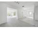 Open-concept living space featuring neutral tile floors, large windows, and bright white walls at 8701 Driftwood Drive Dr, Tampa, FL 33615