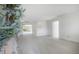 Bright, open living room with light gray tiled floors and freshly painted white walls at 8701 Driftwood Drive Dr, Tampa, FL 33615