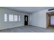 Inviting living room featuring stylish tile flooring, a decorative front door, and a bright window at 8701 Driftwood Drive Dr, Tampa, FL 33615
