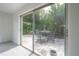 View of the outdoor patio from the home's interior, highlighting the furniture and the inviting backyard space at 8701 Driftwood Drive Dr, Tampa, FL 33615