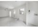 Bright, unfinished room with tile floors, and a view to the backyard at 8701 Driftwood Drive Dr, Tampa, FL 33615