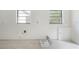 Bright, unfinished room with tile floors, and several windows at 8701 Driftwood Drive Dr, Tampa, FL 33615
