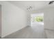 Bright, unfurnished living room with tile floors and light fixtures at 8701 Driftwood Drive Dr, Tampa, FL 33615