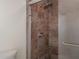 Close-up of the shower featuring tile surround, glass door, and chrome shower head at 8701 Driftwood Drive Dr, Tampa, FL 33615