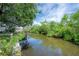 Picturesque waterfront view showcasing a private dock and the calm waterway surrounded by lush vegetation at 8701 Driftwood Drive Dr, Tampa, FL 33615