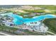 Beautiful aerial view of a large lagoon-style pool with white sand beaches and resort-style amenities at 9098 Forge Breeze Loop, Wesley Chapel, FL 33545