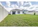 Expansive backyard enclosed by a white fence, providing privacy and security for outdoor enjoyment at 9098 Forge Breeze Loop, Wesley Chapel, FL 33545