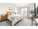 A cozy bedroom with natural light and a calming color scheme, creating a peaceful retreat at 9098 Forge Breeze Loop, Wesley Chapel, FL 33545