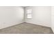 Blank canvas bedroom with neutral carpet and a window, awaiting your personal touch and decor ideas at 9098 Forge Breeze Loop, Wesley Chapel, FL 33545