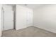 Bedroom with neutral carpet and 2 doors, perfect for creating a peaceful retreat at 9098 Forge Breeze Loop, Wesley Chapel, FL 33545