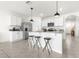 Modern kitchen featuring white cabinets, stainless appliances, granite counters, and an island with seating at 9098 Forge Breeze Loop, Wesley Chapel, FL 33545