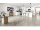 Bright kitchen with white cabinets, granite countertops, an island with seating, and a seamless flow to the living area at 9098 Forge Breeze Loop, Wesley Chapel, FL 33545