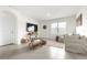 Bright living room with neutral tones and a cozy seating area, perfect for relaxing and entertaining at 9098 Forge Breeze Loop, Wesley Chapel, FL 33545